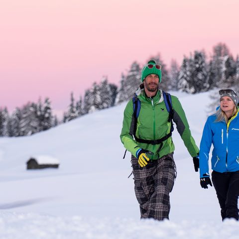 Winter hiking through a snow-covered winter landscape 